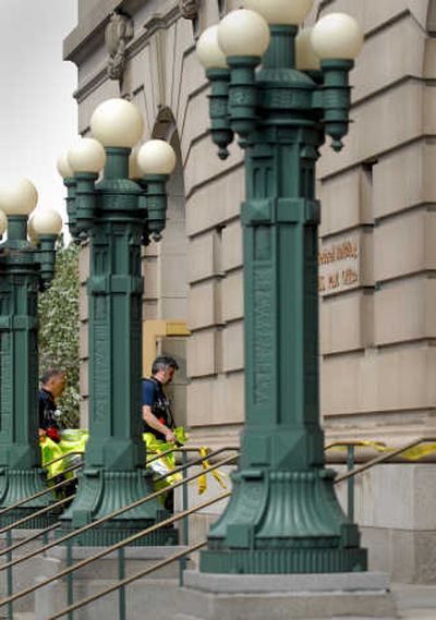 
Hazardous materials workers enter the downtown post office  in Spokane on Thursday. Officials evacuated the building after an envelope containing a suspicious substance was found on the second floor. The envelope was mailed by a prisoner to a judge and contained a threatening note, authorities say. 
 (Brian Plonka / The Spokesman-Review)