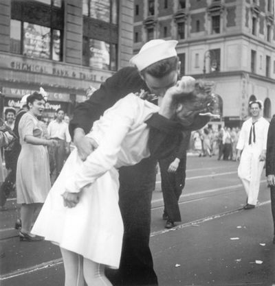 In this Aug. 14, 1945  photo provided by the U.S. Navy, a sailor and a woman kiss in New York's Times Square, as people celebrate the end of World War II. (Victor Jorgensen / Associated Press)