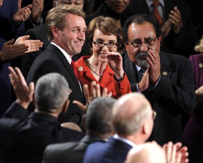 Rep. Gabrielle Giffords, D-Ariz., is flanked by Rep. Jeff Flake, R-Ariz., left, and Rep. Raul Grijalva, D-Ariz., on Capitol Hill in Washington prior to President Barack Obama’s State of the Union address. (Associated Press)