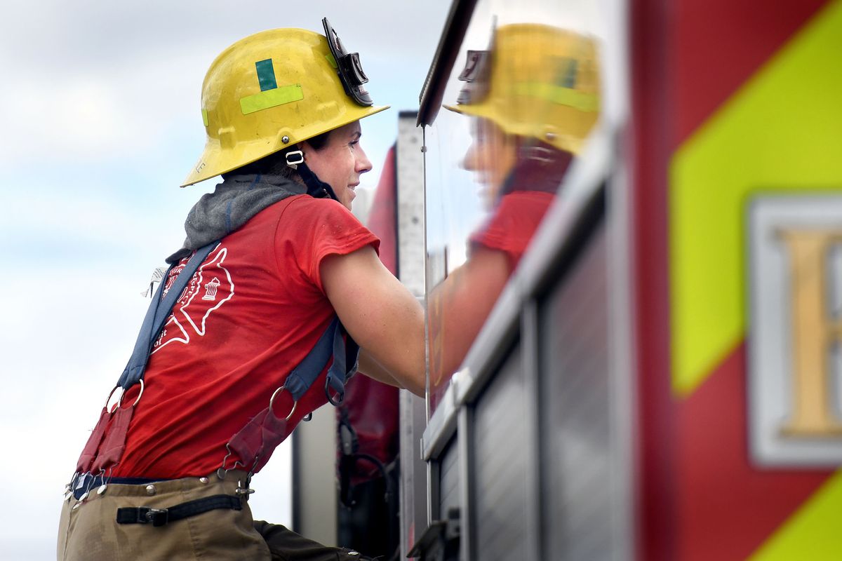 Sharayah Mullerleile, center, climbs to the top of a tanker during training on Monday.  (Kathy Plonka/The Spokesman-Review)