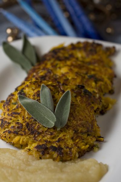 Pan fried till brown with a small amount of olive oil to honor the tradition of cooking with oil at Hanukkah, Butternut Squash and Sage Latkes get finished in the oven to keep them as healthy as possible.  (Associated Press)