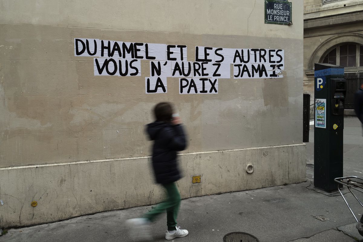 Signs on the wall reads "Duhamel, and the others, you will never be in peace" referring to prominent French political expert, Olivier Duhamel, in Paris, Tuesday, Jan. 19, 2021. The French government pledged on Thursday to toughen laws on the rape of children, as a massive online movement has seen hundreds of victims share accounts about sexual abuses within their families under the hashtag #MeTooInceste.  (Francois Mori)