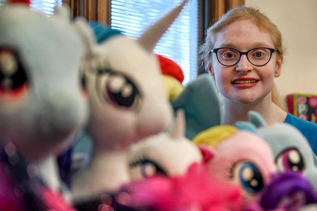 Samantha Warren peeks through a mere sample of her My Little Pony collection at her home in Spokane on Friday. She’s been collecting the ponies since fifth or sixth grade.  (Kathy Plonka/The Spokesman-Review)