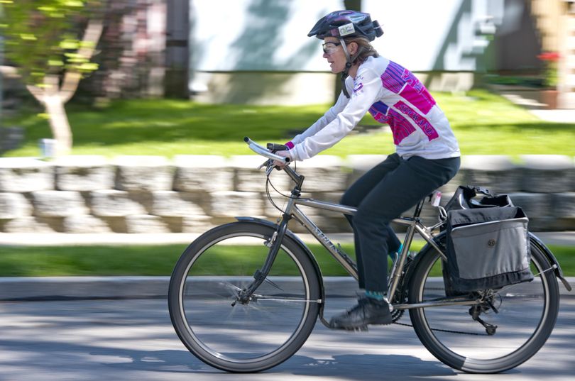 Sally Phillips, shown cycling through her neighborhood, is an avid cyclist and member of the Spokane Bicycle Club and chaired  this year’s Bike to Work Week. She was photographed Friday, May 13, 2016. (Jesse Tinsley / The Spokesman-Review)