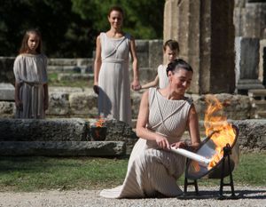 ORG XMIT: XTS101 Maria Nafpliotou, who plays the role of high priestess, lights the flame during a rehearsal for Thursday's ceremony in the temple of Hera for the Vancouver 2010 Winter Games in Ancient Olympia, western Greece, Wednesday, Oct. 21, 2009. (AP Photo/Thanassis Stavrakis) (Thanassis Stavrakis / The Spokesman-Review)