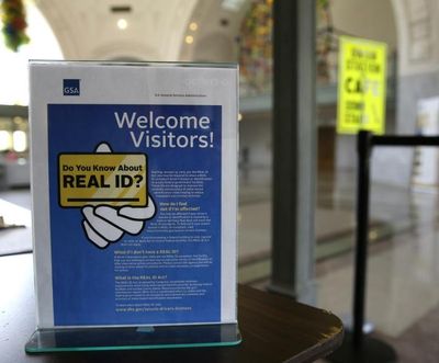In this photo taken April 6, 2016, a sign at the federal courthouse in Tacoma, Wash., is shown to inform visitors of the federal government's REAL ID act, which requires state driver's licenses and ID cards to have security enhancements and be issued to people who can prove they're legally in the United States. (Ted S. Warren / AP)