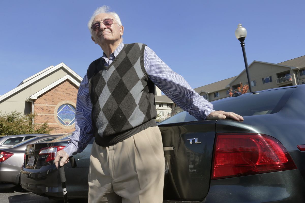 In this photo taken Sept. 25, 2012, Benjamin Benson poses in the parking lot outside his residence at a senior community in Peabody, Mass. Families may have to watch for dings in the car and plead with an older driver to give up the keys _ but there