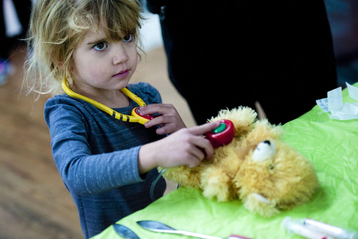 Three-year-old Giulia Lupinacci listens for a heart beat from her bear she named Coffee Maker during the hands on Health clinic designed to help kids feel more comfortable with pediatric checkups. The event was at Be Stil Kids Yoga Studio in Spokane on Saturday, Nov. 17, 2018. (Kathy Plonka / The Spokesman-Review)
