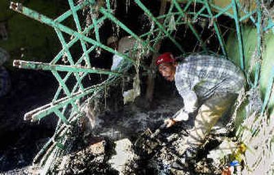 
A man clears mud from a shop Monday in Banda Aceh, Indonesia. After spending nearly two months in camps with little to do, many Acehnese are returning to their damaged homes and shops to rebuild.
 (Associated Press / The Spokesman-Review)