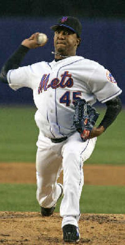 New York Mets starting pitcher Pedro Martinez puts his hand to his