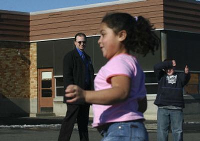 
Madison Elementary School Principal Brent Perdue keeps an eye  on students  Wednesday  during a game of circle tag. His school has also set rules for games such as four square and hopscotch to reduce bickering.
 (The Spokesman-Review)