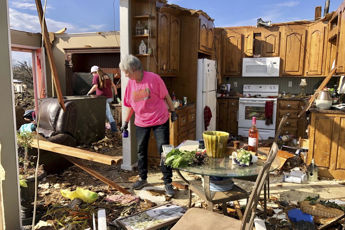 Patti Herring sorts through the remains of her home Tuesday in Fultondale, Ala., after it was destroyed by a tornado. (Jay Reeves)