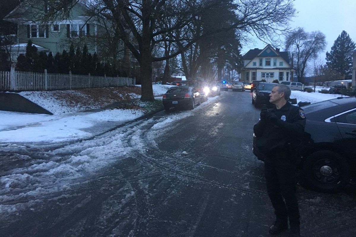 Spokane Police search a South Hill neighborhood near the intersection of 10th and Cannon for a shooting suspect on Dec. 19, 2017. (Ryan Collingwood / The Spokesman-Review)