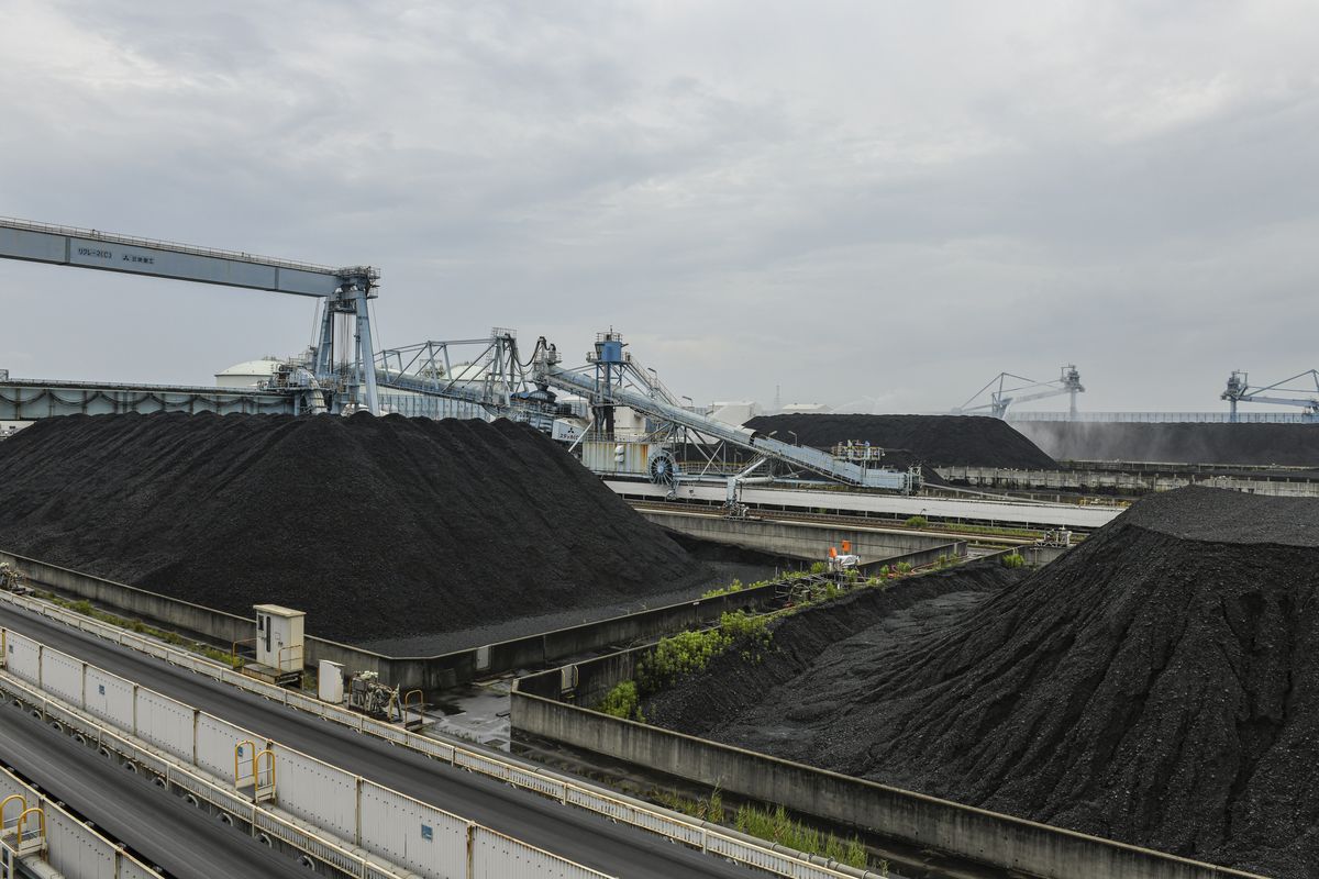 A coal storage yard in Hekina City, Japan, on June 30, 2023. Environmentalists say the war in Iran’s effects on oil and gas prices are an argument for countries to get off fossil fuels. But the reality is likely to be messier. (New York Times file photo)