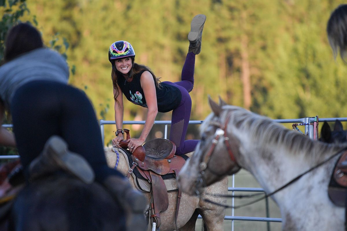 Briana Randall leads her class during Sunset Cowgirl Yoga on Tuesday, July 30, 2019, at Sunset Arena in Cheney. (Tyler Tjomsland / The Spokesman-Review)