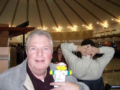 
Flat Stanley, a paper cutout of the children's book character, is carried at the Spokane airport by George Washington. He's on his way to Sun City, Ariz. Next stop: Mexico!  
 (Courtesy of Ann Washington / The Spokesman-Review)