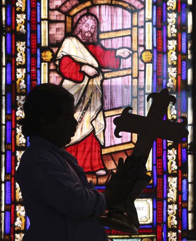 An Indian worker cleans a crucifix at a church ahead of Christmas in Hyderabad, India, Thursday, Dec. 22, 2011. Christians make up about 2 percent of India's 1 billion-plus population. (Mahesh A / Associated Press)
