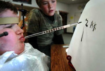 
Zak Baldwin, 10, displays his skills painting with his mouth at Reardan Elementary School on Oct. 30. 
 (Photo by JED CONKLIN / The Spokesman-Review)