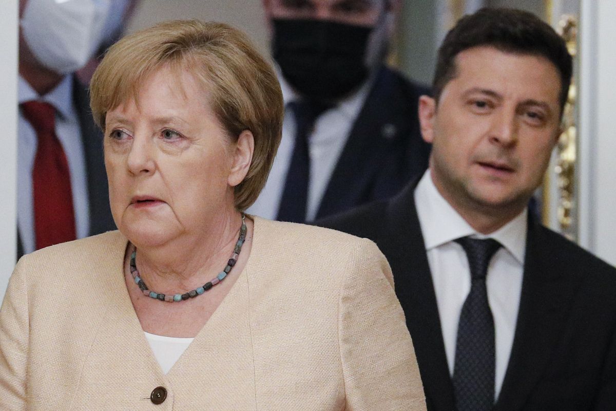 Ukrainian President Volodymyr Zelenskyy, right, and German Chancellor Angela Merkel enter a hall for a joint news conference following their talks at the Mariinsky palace in Kyiv, Ukraine, Sunday, Aug. 22, 2021. German Chancellor Angela Merkel arrived to Kyiv for a working visit to meet with top Ukrainian officials.  (Sergey Dolzhenko)