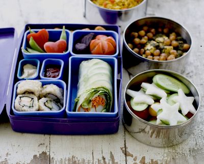 A Japanese bento box and Indian tiffin shown here offer a multinational version of the traditional brown bag lunch. (Associated Press)