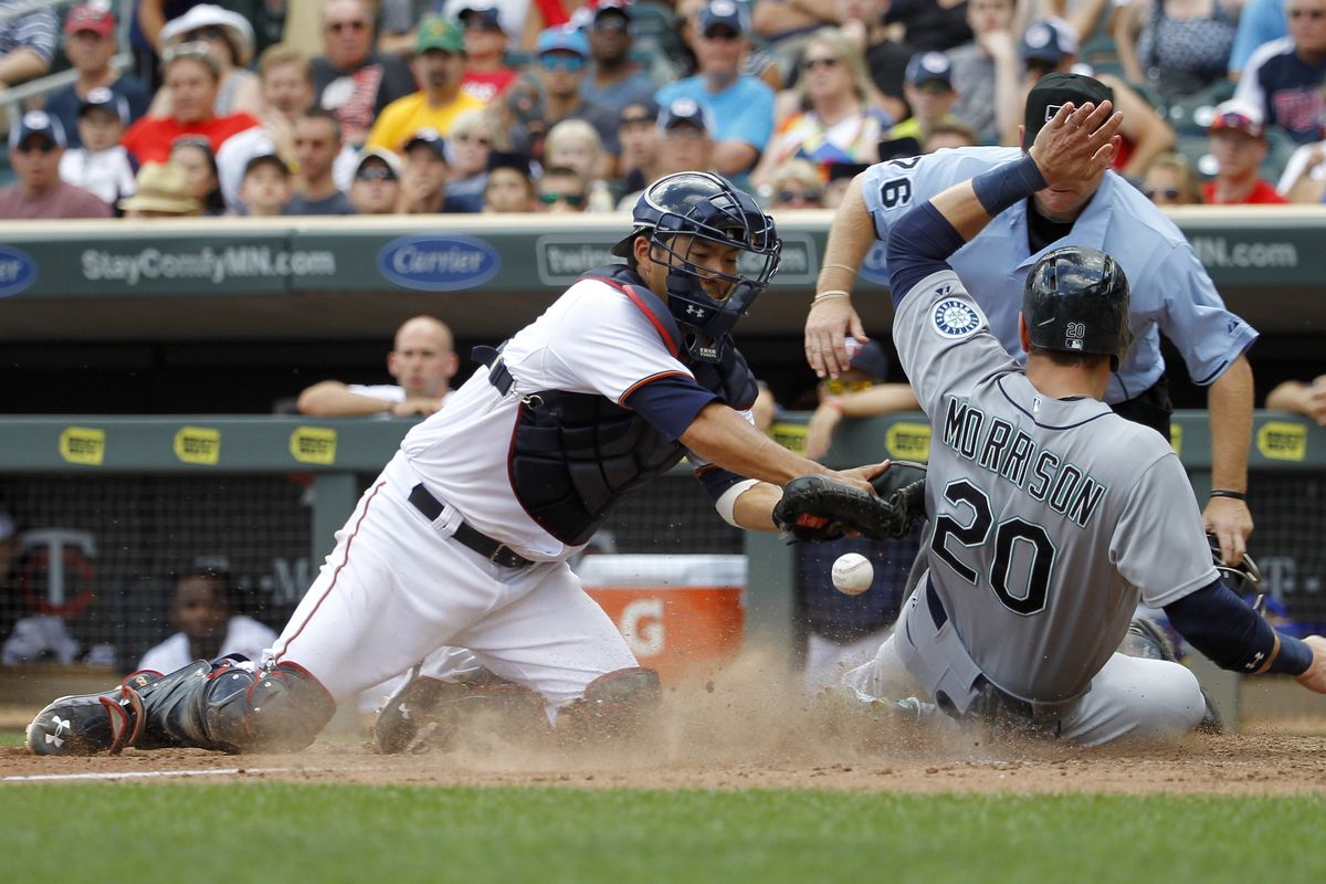 Logan Morrison, who drove in the go-ahead run in the 11th, scores on a single by Austin Jackson to pad the lead. (Associated Press)