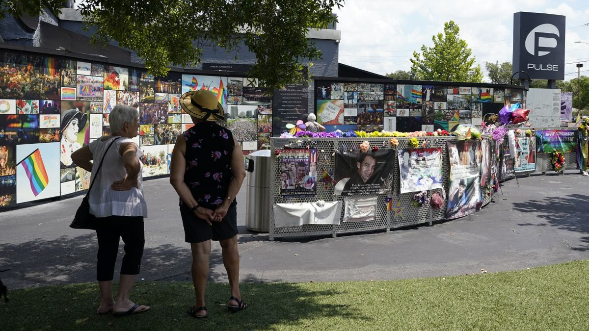 Visitors pay tribute to the display outside the Pulse nightclub memorial Friday, June 11, 2021, in Orlando, Fla. Saturday will mark the fifth anniversary of the mass shooting at the site.  (John Raoux)