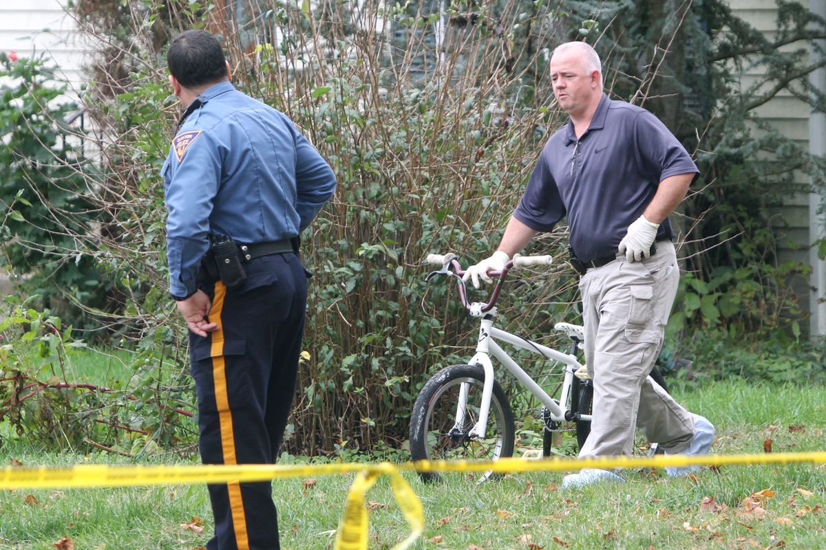 Police remove a bicycle from a home near where a 12-year-old Autumn Pasquale