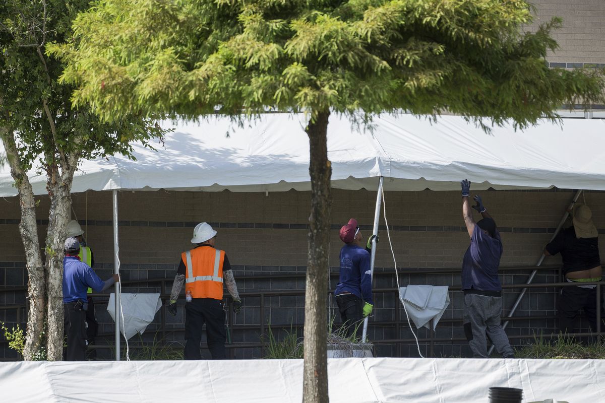 A construction crew works to set up tents that hospital officials plan to use with an overflow of COVID-19 patients outside of Lyndon B. Johnson Hospital, Monday, Aug. 9, 2021, in Houston.  (Godofredo A. Vásquez)