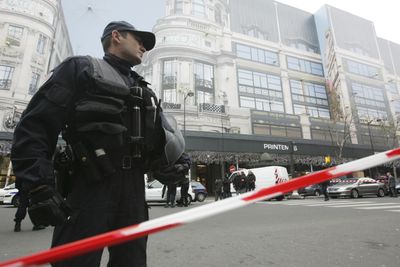 Police officers cordon off a Paris department store after a bomb alert Tuesday in Paris. France’s national news agency said it received a claim of responsibility from an Afghan group.  (Associated Press / The Spokesman-Review)