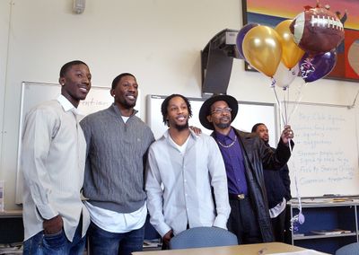 Washington recruit Desmond Trufant of Tacoma, left, poses with (left to right) brothers Marcus and Isaiah, and father Lloyd.  (Associated Press / The Spokesman-Review)