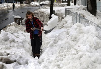 Tristan Firestone digs out his sidewalk for the third time this winter on the 700 block of East 37th Avenue in Spokane on Wednesday. Firestone, 25, has been shoveling roofs for the past two weeks and took the day off to clear the walk. He says lifting the heavy snow is like lifting rock.  (Dan Pelle / The Spokesman-Review)