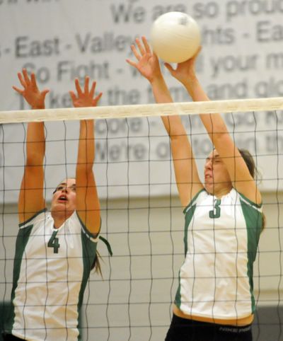 Alyssa Dorr, left, and Amber Swyers put up a block against the Cheney Blackhawks  at East Valley High School on Tuesday. The Knights beat the Blackhawks 3-1.  (Jesse Tinsley)