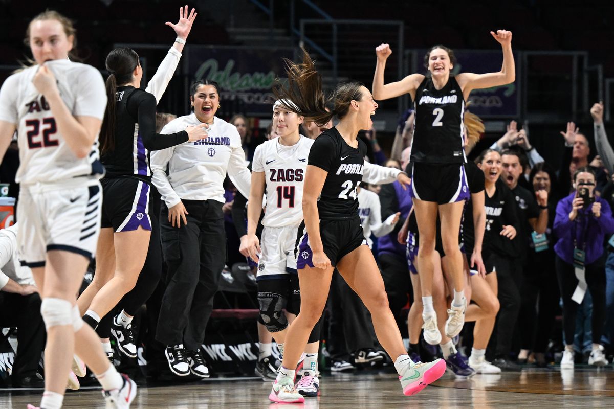 Portland Pilots guard Maisie Burnham (24) celebrates defeating the Gonzaga Bulldogs as Gonzaga Bulldogs guard Kaylynne Truong (14) and guard Brynna Maxwell (22) head to the locker room during the second half of a WCC women’s championship basketball game on Tuesday, Mar 12, 2024, at Orleans Arena in Las Vegas, Nev. Portland won the game 67-66.  (TYLER TJOMSLAND/THE SPOKESMAN-REVIEW)