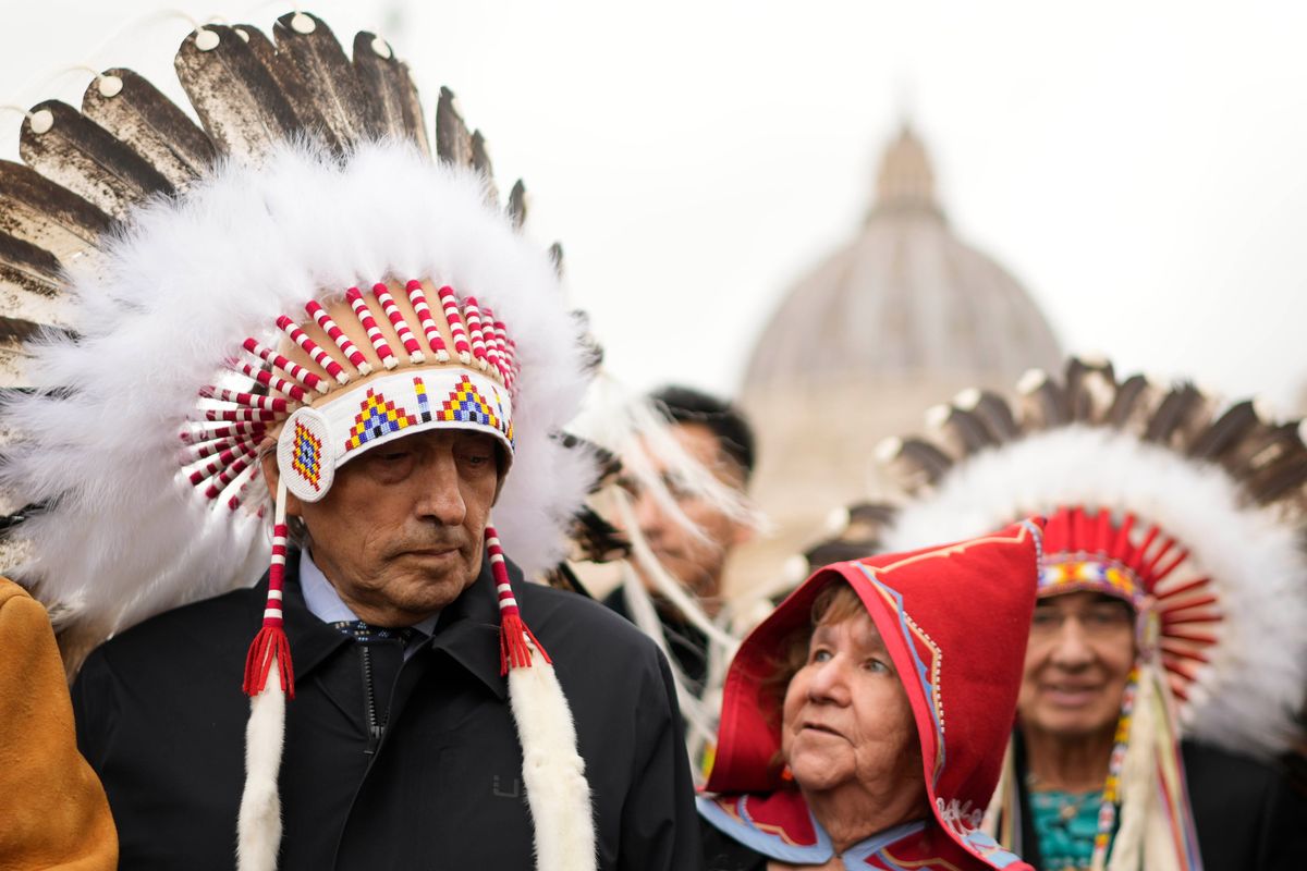 Former national chief of the Assembly of First Nations, Phil Fontaine, left, stands outside St. Peter’s Square at the end of a meeting Thursday with Pope Francis at the Vatican.  (Andrew Medichini)