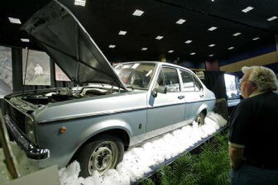 
Ardell Brown surveys the 1975 Ford Escort GL that was once owned by Pope John Paul II in Las Vegas on Saturday. The car was sold to a Houston multi-millionaire. 
 (Associated Press / The Spokesman-Review)