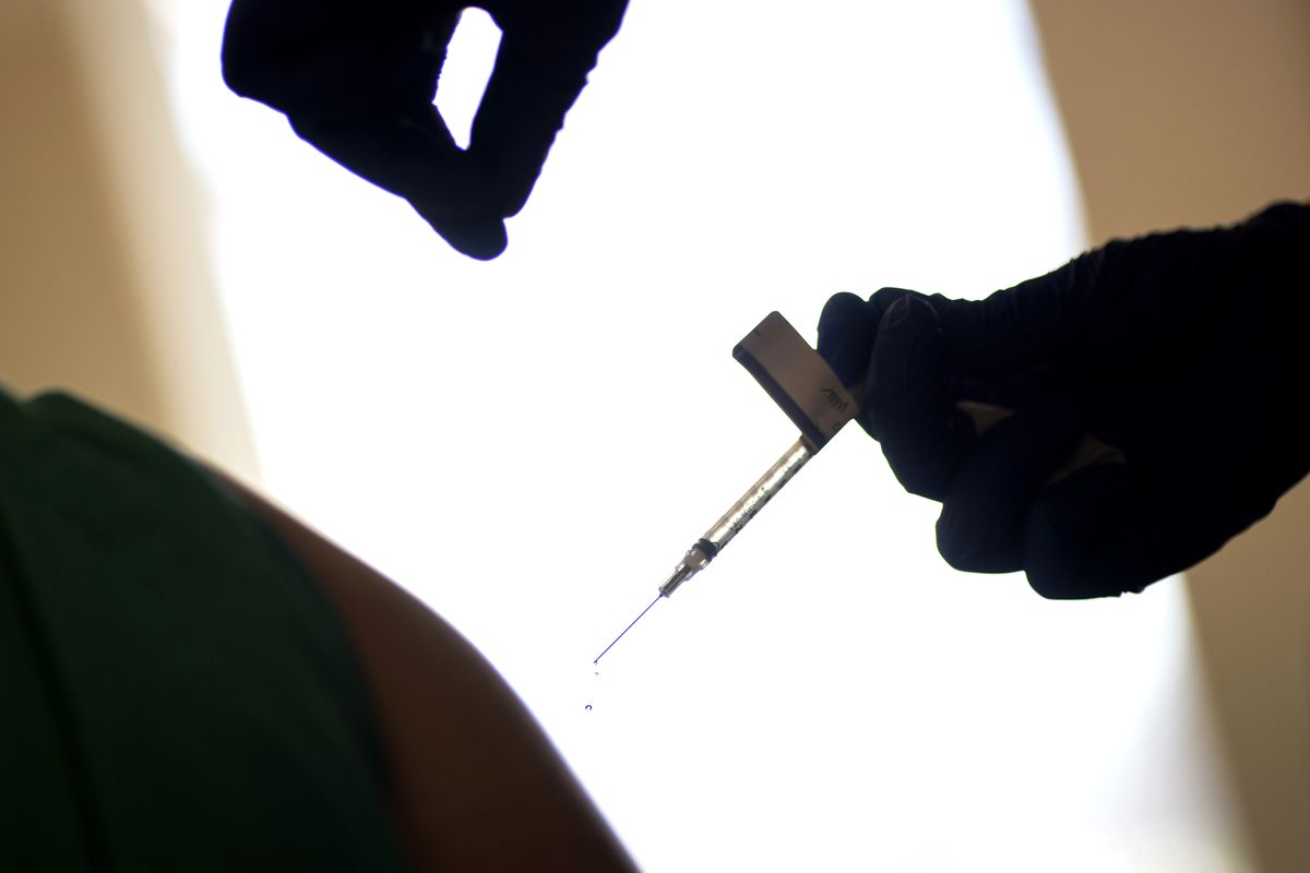 A droplet falls from a syringe after a health care worker was injected with the Pfizer-BioNTech COVID-19 vaccine at Women & Infants Hospital in Providence, R.I., Tuesday, Dec. 15, 2020. (David Goldman)