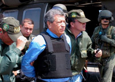 
Confessed drug trafficker, Miguel Rodriguez Orejuela, center, is escorted by police officers to a U.S. government airplane at the Palanquero Air Base in central Colombia in March 2005. 
 (Associated Press / The Spokesman-Review)
