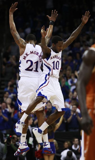 Kansas forward Markieff Morris (21) and guard Tyshawn Taylor (10) celebrate during the Jayhawks’ win over Texas in the Big 12 finals. (Associated Press)