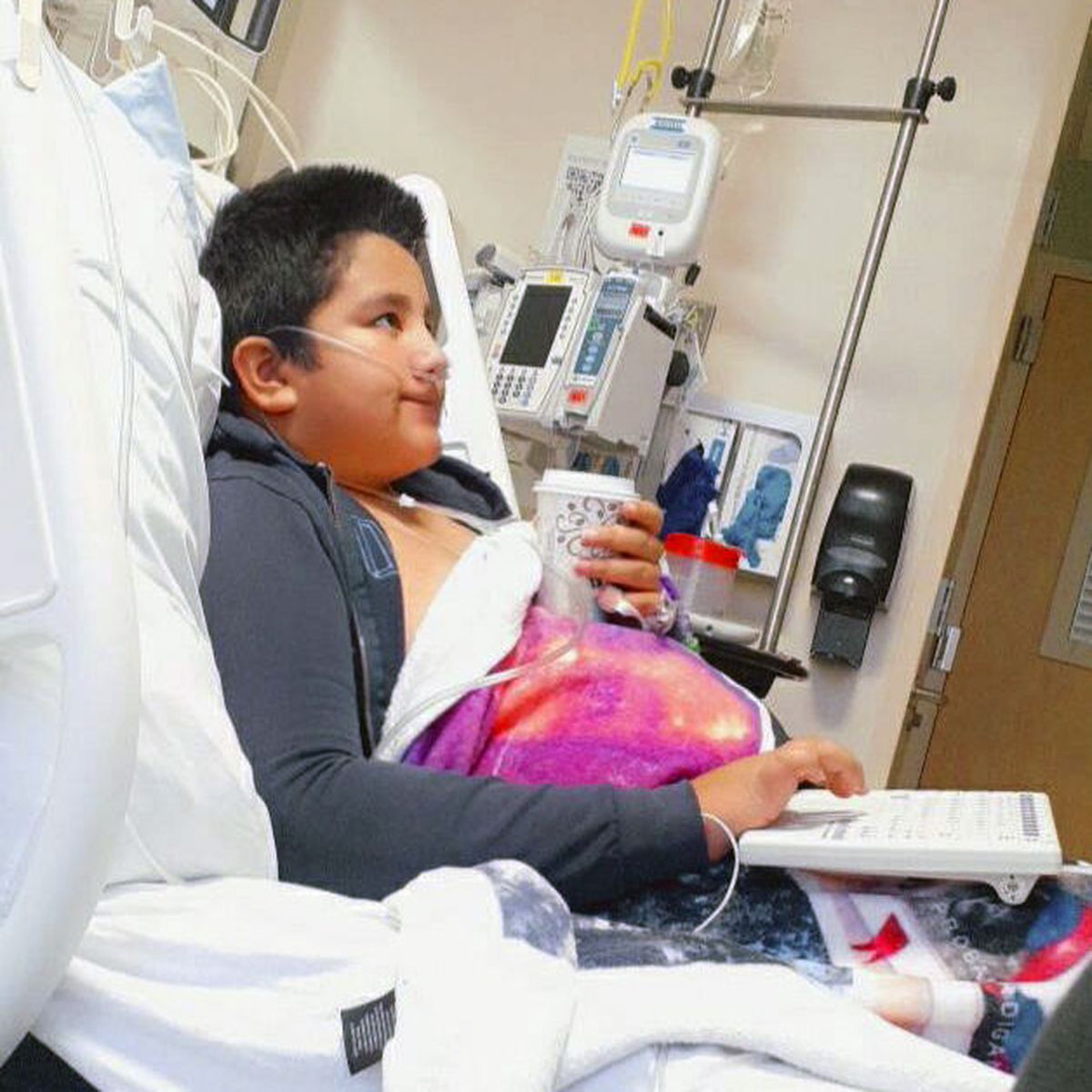 This 2021 photo provided by Yessica Gonzalez shows her son, Francisco Rosales, 9, in the intensive care unit at Children’s Medical Center in Dallas, Texas. The day before he was supposed to start fourth grade, Francisco was admitted to the hospital due to severe COVID-19, struggling to breathe, with dangerously low oxygen levels and an uncertain outcome.  (Yessica Gonzalez)