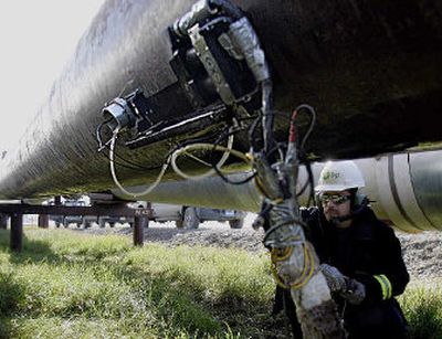 
Bob Newton uses ultrasound last Friday to scan a section of pipe, looking for weak spots along an oil pipeline  at the Prudhoe Bay oil field on Alaska's North Slope. 
 (Associated Press / The Spokesman-Review)