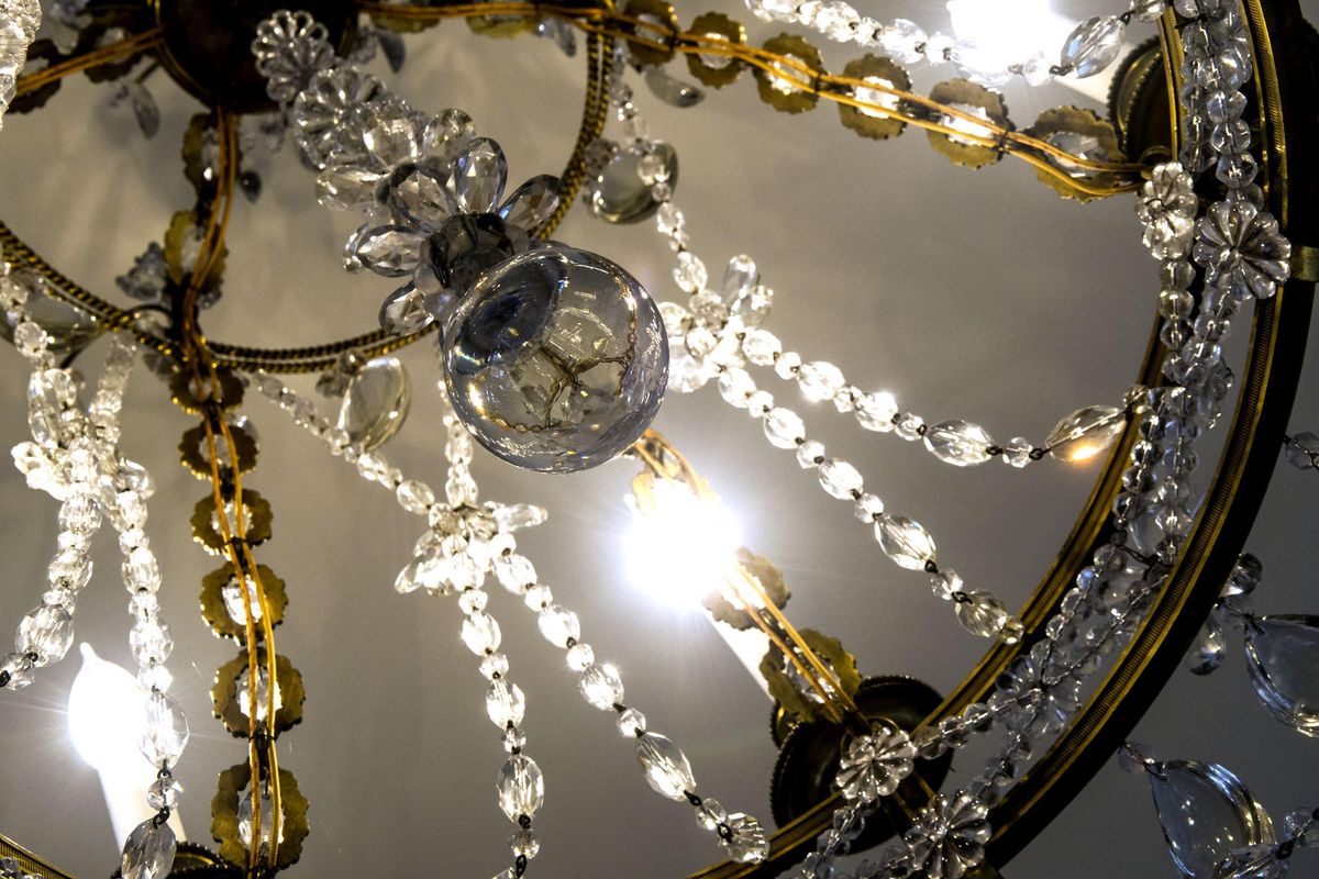 A chandelier illuminates a room in this historic home at Sanders Beach in Coeur d’Alene on Monday, Feb. 5, 2018. This home is on the market for just under $8 million. (Kathy Plonka / The Spokesman-Review)