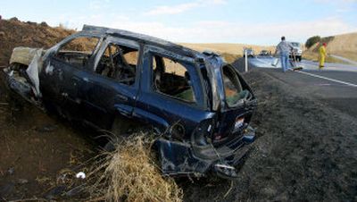 
An SUV that rolled early Friday sits in a ditch as road crews clear U.S. Highway 195 of debris. The accident caused two deaths and three more people to be transported to nearby hospitals. 
 (Kody Whiteaker Special to the Spokesman-Review / The Spokesman-Review)