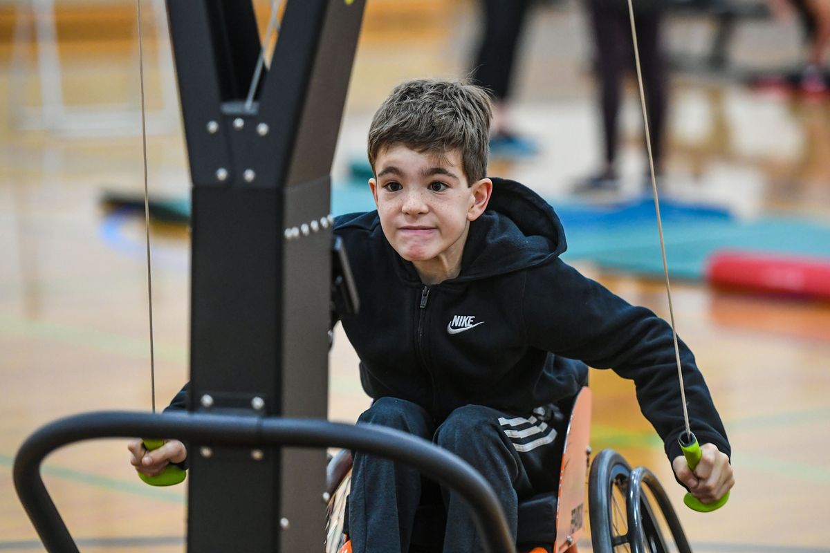 Jack Coy, 11, born with mild cerebral palsy, works on a SkiERG machine during a ParaSport strength and conditioning session Feb. 8 at Valley Christian High School in Spokane.  (Dan Pelle/The Spokesman-Review)