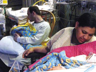 Shane and Sarah Reinfelder, of Sault Ste. Marie, Mich., hold their twin girls, Valerie Marie and Kaylin Joy, who were born from two  uteri at Marquette General Hospital Friday in Marquette, Mich.  (Associated Press / The Spokesman-Review)