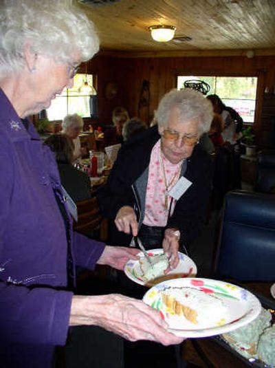 
Ladies of the Lake members JoAnn Everett and Dorothy Sales serve homemade cake at the Hauser group's October meeting.
 (Hope Brumbach / The Spokesman-Review)