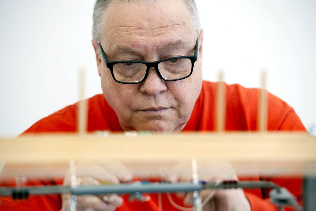 Artist-bookbinder Timothy Ely uses a sewing frame while building a book at North Spokane Library on Wednseday, Oct. 3, 2018. (Kathy Plonka / The Spokesman-Review)
