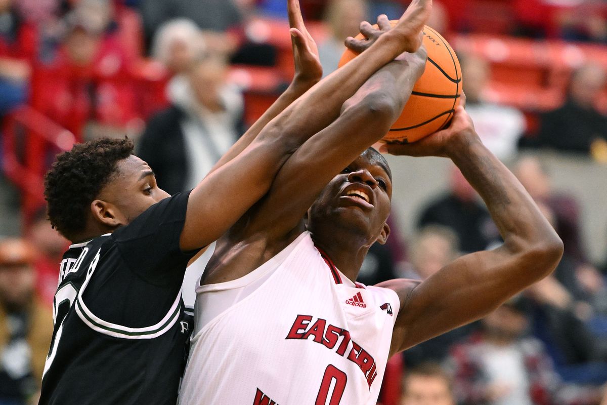 Eastern Washington Eagles guard Cedric Coward, right, passes the ball against Portland State Vikings guard Jorell Saterfield at Reese Court last month in Cheney.  (James Snook/For The Spokesman-Review)