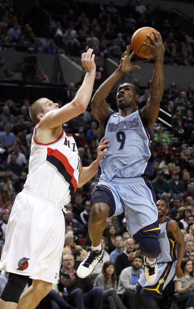 Memphis Grizzlies’ Tony Allen, right, drives to the basket against Trail Blazers’ Joel Przybilla in Thursday’s game at Portland. (Associated Press)