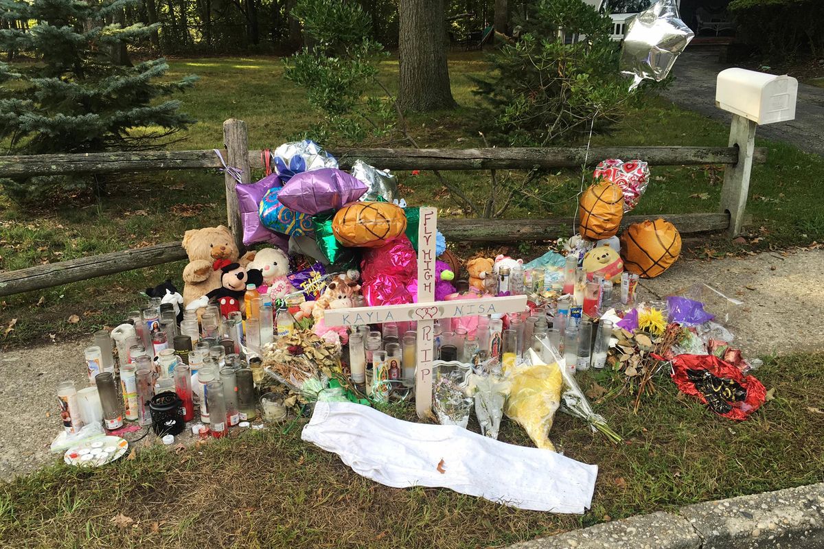 In this Sept. 27, 2016, file photo, a memorial to best friends Nisa Mickens and Kayla Cueva is seen near the spot where their bodies were found in Brentwood, N.Y. (Claudia Torrens / Associated Press)
