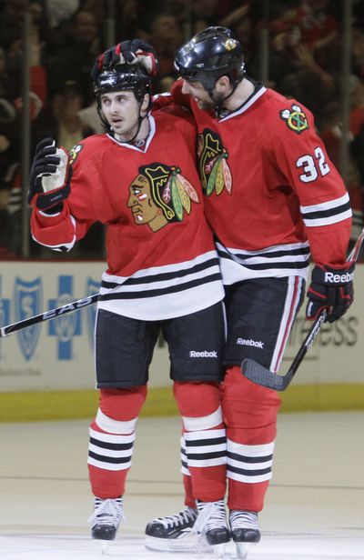 Chicago’s Dave Bolland, left, and John Scott celebrate Bolland’s 2nd-period goal. (Associated Press)